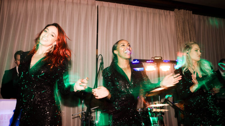 Live wedding band singers performing on stage at a wedding event by Ben Mallare Events & Entertainment, featuring vibrant lighting and energetic atmosphere.