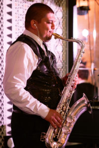 Saxophonist performing live at a wedding event, showcasing Ben Mallare Events & Entertainment's exceptional live wedding band services.