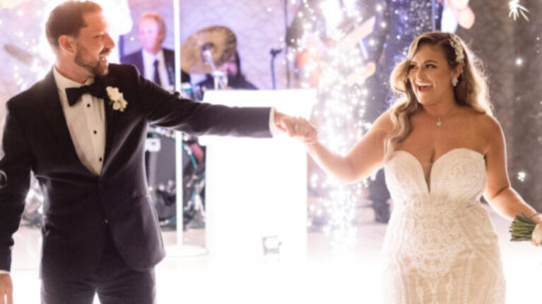 Bride and groom dancing at their wedding with a live wedding band from Ben Mallare Events & Entertainment performing in the background, featuring a 20-piece band on stage.