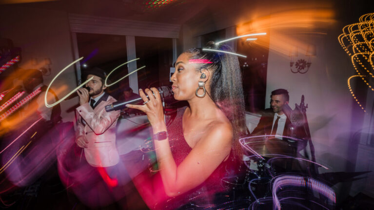 A vibrant live wedding band from Ben Mallare Events & Entertainment performing on stage, featuring multiple musicians and singers, creating an energetic atmosphere for a wedding celebration.