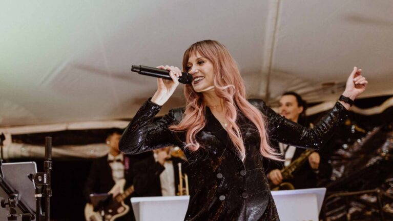 Lead singer performing with a live wedding band from Ben Mallare Events & Entertainment, featuring multiple musicians on stage, perfect for wedding receptions and events.