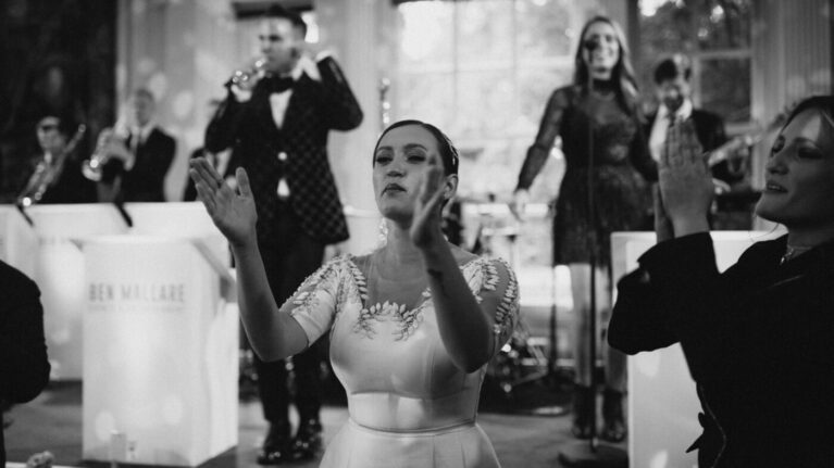 A 20-piece live wedding band from Ben Mallare Events & Entertainment performing on stage, featuring musicians and singers in elegant attire, creating an unforgettable wedding reception experience.