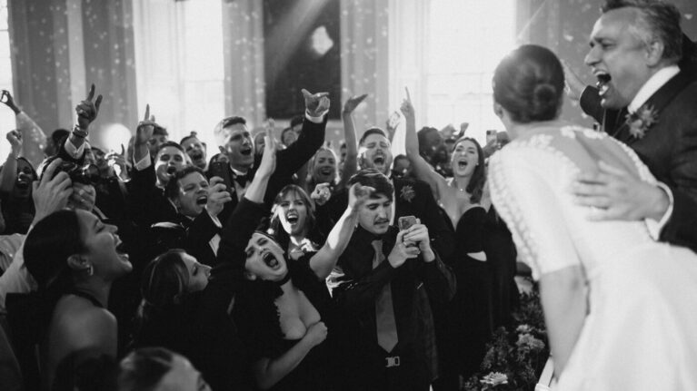 A lively moment at a wedding featuring a 20-piece wedding band, with guests enthusiastically enjoying the performance. The crowd is captured in a joyous celebration, showcasing the vibrant atmosphere created by live wedding bands. This image emphasizes the excitement and energy that Ben Mallare Events & Entertainment brings to unforgettable wedding experiences.