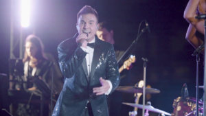 Lead singer performing with a live wedding band from Ben Mallare Events & Entertainment, showcasing a vibrant 20-piece ensemble on stage.